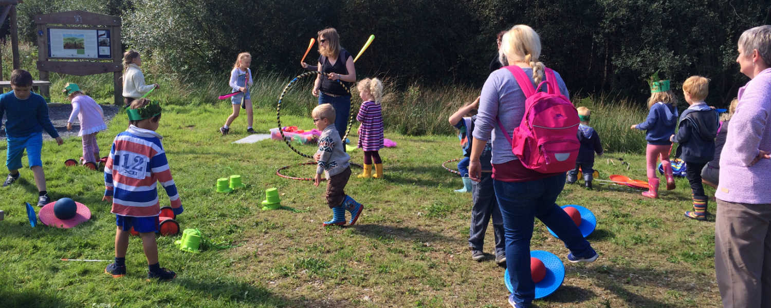 Children playing games outside on the grass