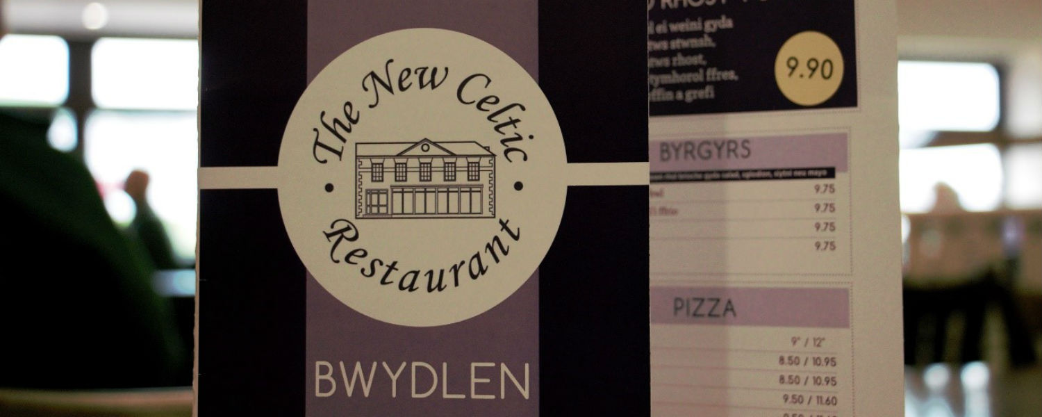 Celtic menu close up with restaurant in background