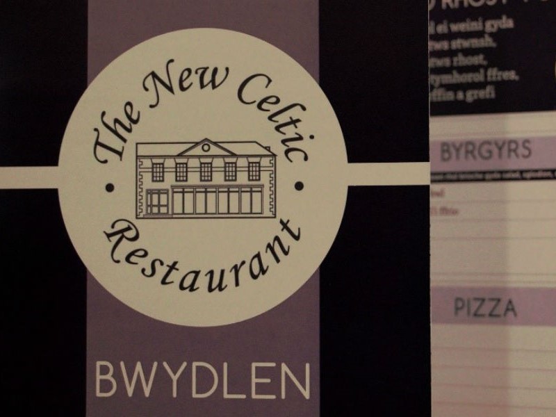 Celtic menu close up with restaurant in background