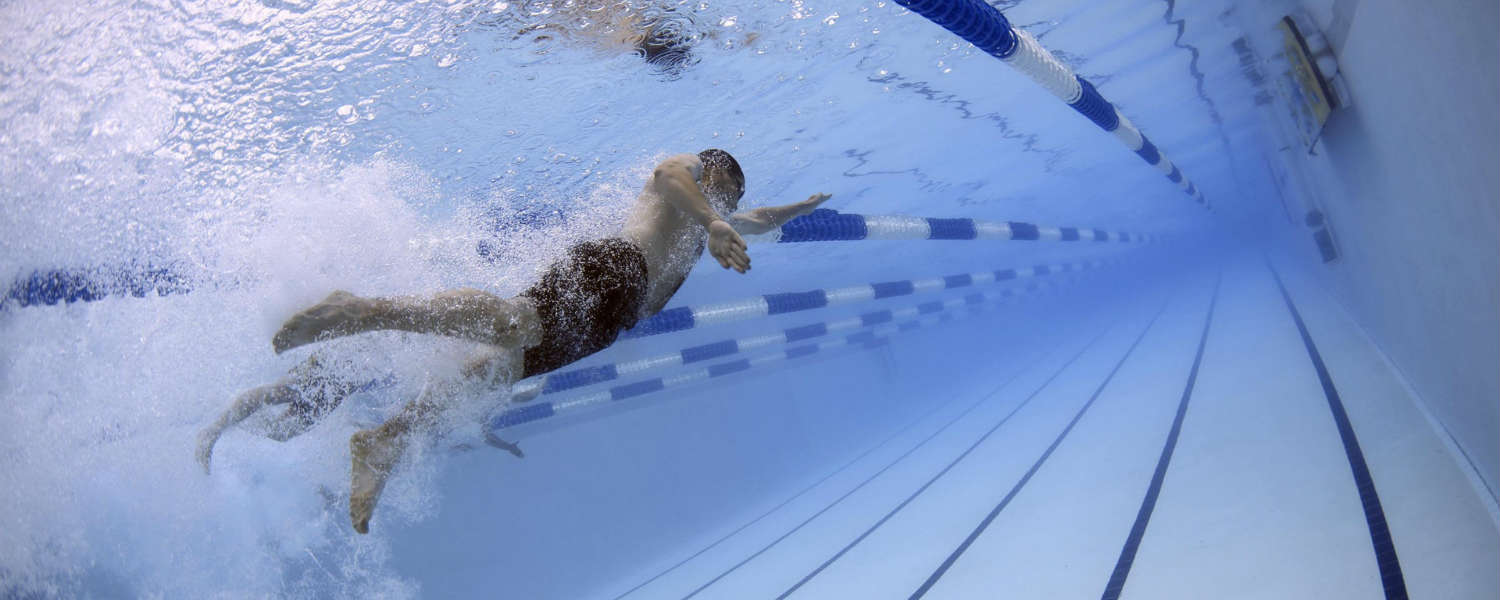 Underwater view of man swimming in swimming pool