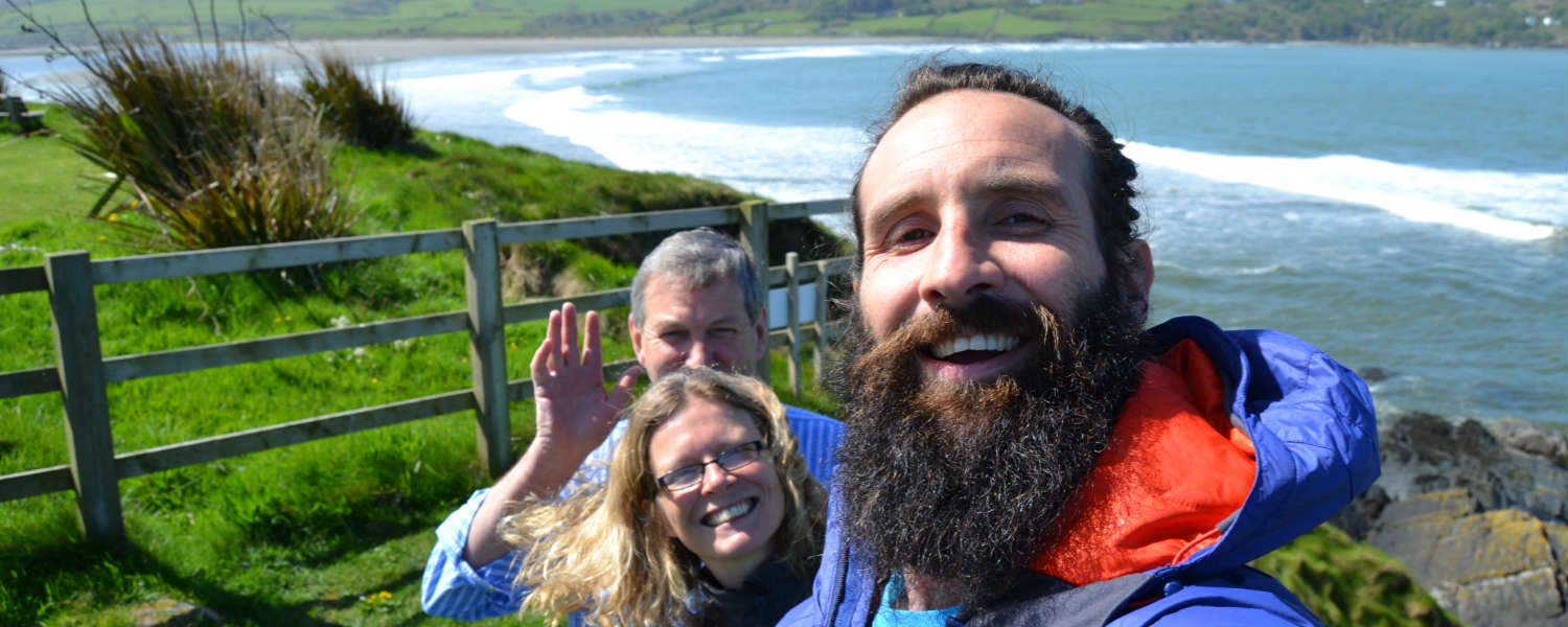 3 people taking a selfie picture with Cardigan Bay in the background