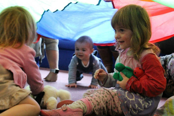1-3 year old children playing in a tent
