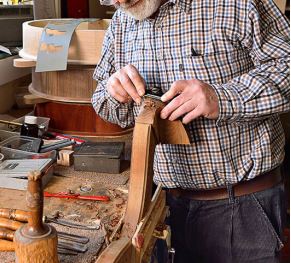 Man making a wooden harp